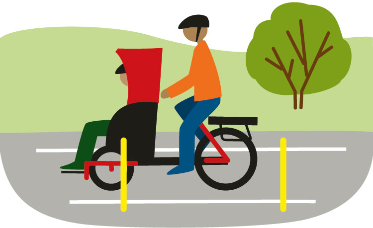 Två personer åker fram längst en väg, på en cykel med dels ett vanligt cykelsäte, dels en sittplats fram.