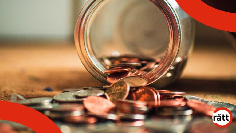 En mängd småmynt väller ut ur en glasburk och täcker marken.